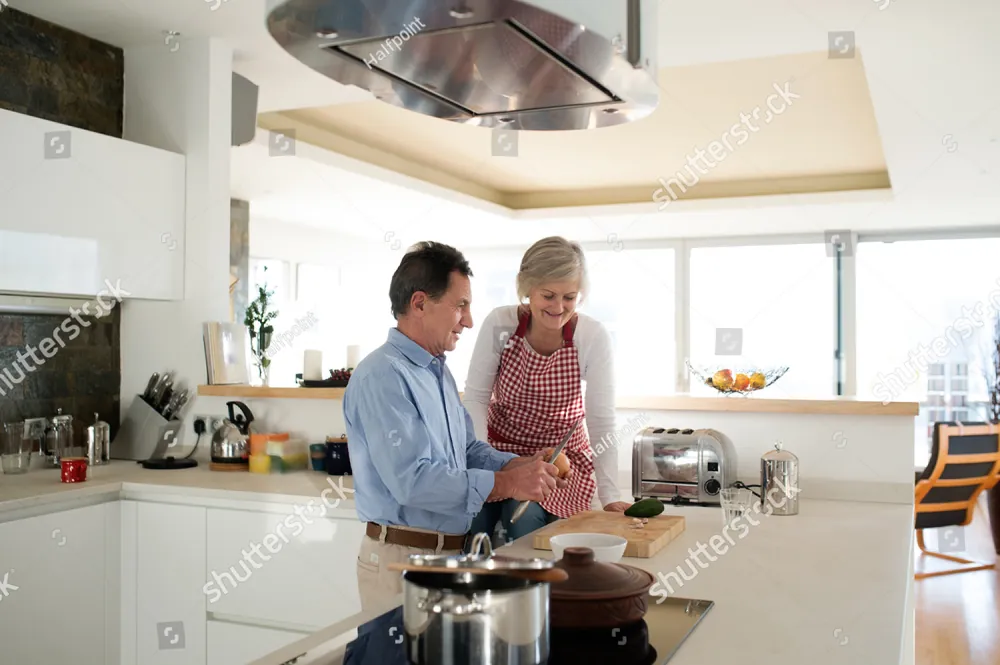 A man and a woman cooking together in a bright kitchen